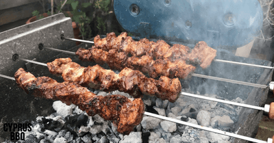 Belly Pork Souvlaki Kebabs cooked over charcoal on a Cyprus rotisserie BBQ